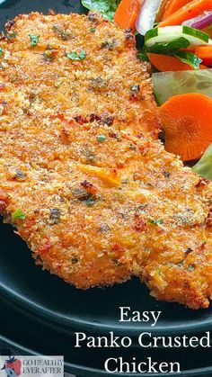 an easy panko crusted chicken cut in half on a plate with salad and carrots