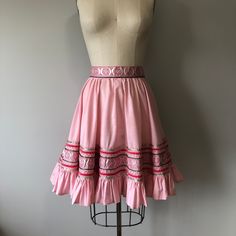 "A beautiful handmade vintage skirt in perfect condition! Size: L Tag - none Era - 50s Material - cotton, ric rac, ribbons (blend), velvet ribbon, metal zipper, metal snap button Waist - 28 to 30\" Hips - free Length - 22\" Washing - lightly steam clean or hand wash cold delicately, hang to dry" Vintage Pleated Mini Skirt, Vintage Ruffled Skirt Petticoat, Vintage Tiered Petticoat With Lined Skirt, Vintage Skirted Petticoat With Lined Skirt, Vintage Cotton Lined Skirt, Vintage Gathered Flared Skirt, Vintage Flared Gathered Skirt, Vintage Fitted Skirted Skirt, Vintage Fashion Flared Lined Skirt