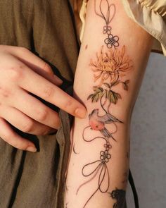 a woman's arm with flowers on it