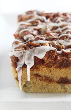 a close up of a cake on a plate with icing drizzled