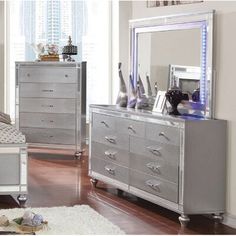 a bedroom scene with focus on the dresser and bed, which has been decorated in silver