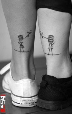 two people with tattoos on their legs