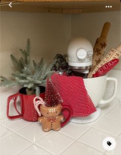 a cup filled with christmas items on top of a counter