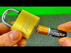 a person holding a yellow padlock over a green background with the words duracell on it