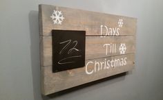 a wooden sign that says days till christmas