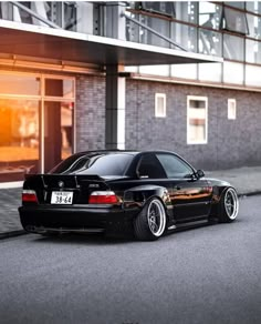 a black car parked in front of a building