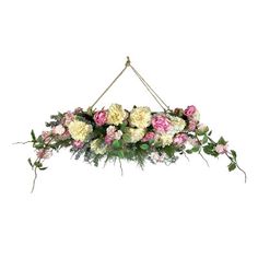 an arrangement of flowers hanging from a rope