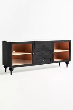 the sideboard has two drawers and one shelf with three open doors on each side