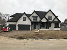 a truck parked in front of a house under construction