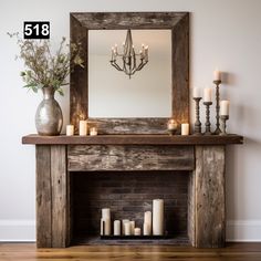 a fireplace with candles and a mirror above it