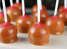 caramel apples with white sticks sticking out of them