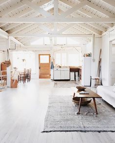 an open living room with white walls and wood flooring is pictured in this image