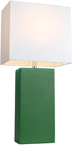 a green table lamp with a white shade on the top and bottom part of it