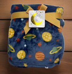 a blue blanket with yellow stars and planets on it