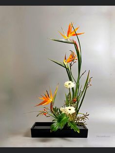 an arrangement of flowers in a black vase