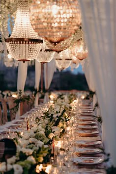 a long table is set up with candles and place settings for an elegant dinner party