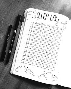 an open notebook with the words sleep log written on it and two black pens next to it