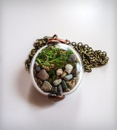 a necklace with moss and rocks in it