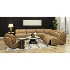 a living room with a large sectional couch and two chairs in front of a coffee table