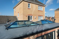 an image of a roof with skylights on the top and side of houses in the background