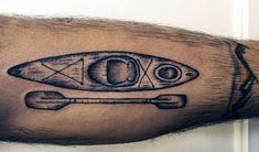 a man's arm with a boat and oars on it