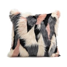 a black and white pillow with multicolored fur on the front, sitting against a white background