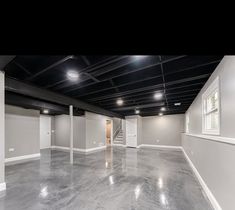 an empty room with white walls and black ceilinging is seen in this image from the inside