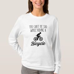 a woman wearing a white shirt that says biking is not the only way to do it