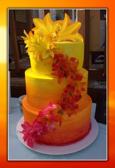 there is a three layer cake with flowers on the top and bottom, decorated with yellow icing