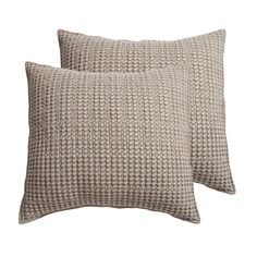 two pillows on a white background, one is brown and the other is beige with squares