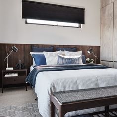 a bedroom with a large bed and wooden headboard