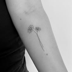 a black and white photo of a flower on the arm