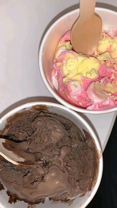 two bowls filled with chocolate and colored food