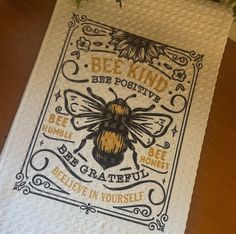 a towel with a bee on it sitting on top of a table