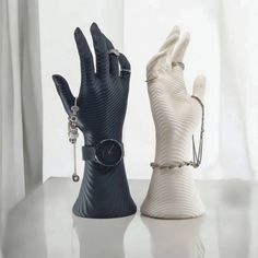 two white gloves and a watch on a table