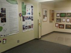 a hallway with posters and pictures on the wall