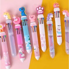 several different pens lined up next to each other on a yellow and pink background,