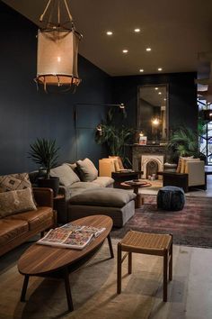 a living room filled with furniture and a fire place in the middle of it's wall