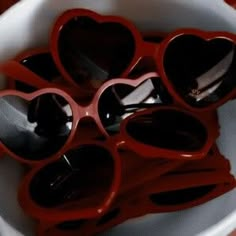 red heart shaped glasses in a white bowl