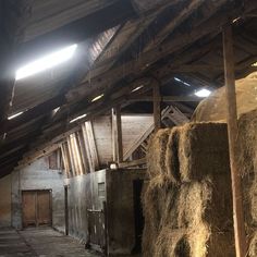 an old barn with hay bales in it