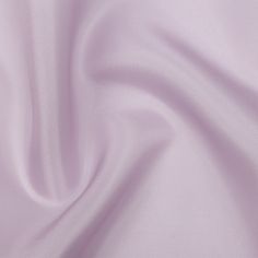 a close up view of a light purple fabric