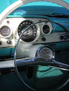 the interior of an old car with gauges and dash lights