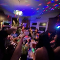 a group of people sitting at a table with drinks and confetti in front of them