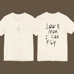 Look Mom I Can Fly Shirt, Cactus Jack Tee, Travis Scott Cactus Jack T-shirt, Cactus Jack Merch, Travis Scott Cactus Jack Tee, Unisex Tee This classic unisex jersey short sleeve tee fits like a well-loved favorite. Soft cotton and quality print make users fall in love with it over and over again. These t-shirts have-ribbed knit collars to bolster shaping. The shoulders are tapered for a better fit over time. Dual side seams hold the garment's shape for longer.  .: Made with 100% Airlume combed an Cactus Jack Shirt, Travis Scott Aesthetic, Look Mom I Can Fly, Travis Scott Cactus Jack, Devin Booker, Cactus Jack, Tshirt Outfits, Diy Shirt, Travis Scott