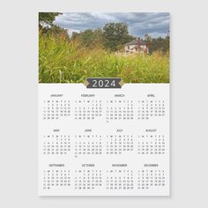 a 2013 calendar with the image of a house and trees in the background, on a white