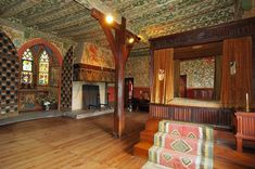 an ornate bedroom with wood floors and walls