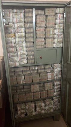 a large metal cabinet filled with lots of papers and folders on top of each other