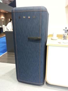 a blue refrigerator sitting next to a white counter