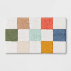 a multicolored rug with squares on the front and back, in various colors