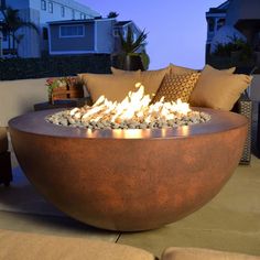 a large fire pit sitting on top of a patio